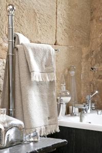 a bathroom with a towel hanging over a sink at Chateau de Lissac in Lissac-sur-Couze