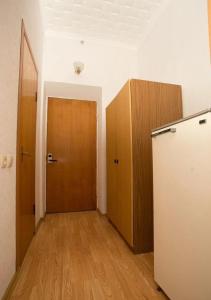 an empty room with a door and a wooden floor at Zhemchuzhina Kavkaza Hotel in Zheleznovodsk