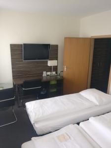 Voodi või voodid majutusasutuse Behringers City Hotel Nürnberg toas