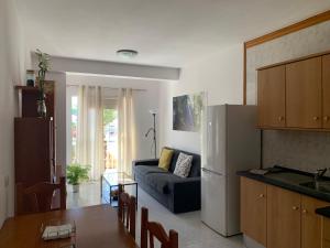 a kitchen and a living room with a couch at 7tierras in El Paso