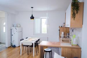 a kitchen with a table and some chairs in a room at Apartments Dolores in Šibenik
