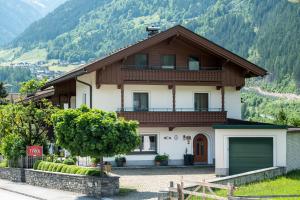 a house in the mountains with a garage at Landhaus Tyrol in Mayrhofen