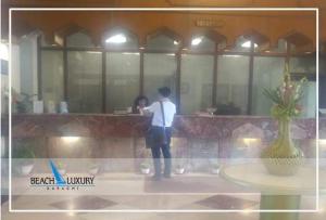 a man taking a picture of himself in a mirror at Beach Luxury Hotel in Karachi