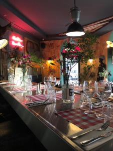 a table in a restaurant with wine glasses on it at Hôtel Le G (ex Le Genève) in Nice