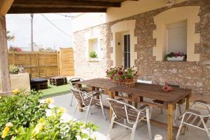 a wooden table and chairs on a patio at Casa Josep in Camarles