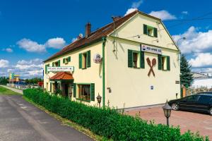 a building with a ribbon on it on a street at Zajazd Pod Lipami in Lipno