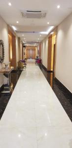 a hallway of a hotel with a large white tile floor at Elite of Elite Hotel Apartments in Riyadh