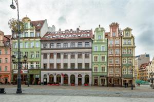a row of colorful buildings in a city at Abba Apartments in Wrocław