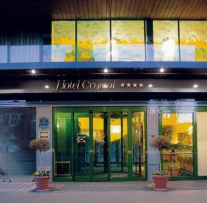 a hotel gustessential sign on the front of a building at Crystal Hotel Varese in Varese