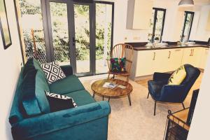 a living room with a couch and chairs and a table at Fowey Landing in Fowey +15 photos