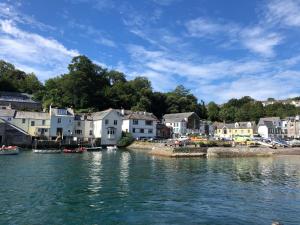 a view of a town from the water with houses at Fowey Landing in Fowey