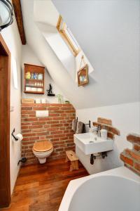 a bathroom with a sink and a brick wall at Apartmán u Brány in Prachatice