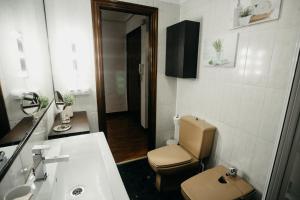 a small bathroom with a toilet and a sink at Ubicación excelente cerca de Centro Azkuna in Bilbao +31 photos