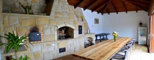 a room with a stone fireplace and a wooden table at Chalupa Bohunka in Bouzov