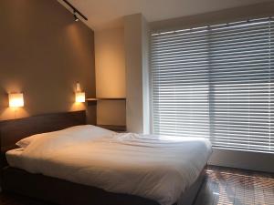 Condominium MIRAHAKONE客房内的一张或多张床位