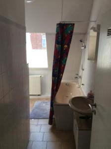 a bathroom with a sink and a shower curtain at Rilke in Markkleeberg