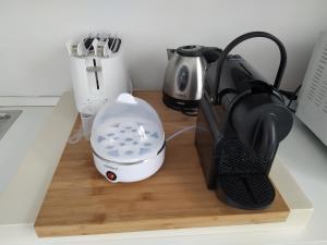 a kitchen counter with a mixer and a coffee maker at La mansarda sul Porto in Camogli