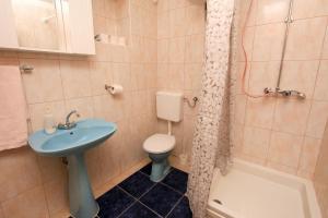 a bathroom with a sink and a toilet and a shower at Robinson Tabinja in Sućuraj +20 photos