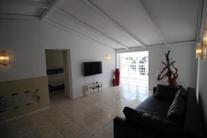 a living room with a couch and a television at Sunny House, Chayofa in Chayofa