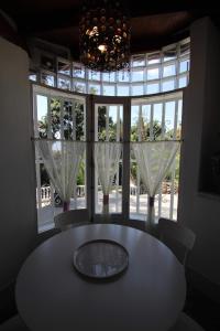 a table and chairs in a room with a large window at Sunny House, Chayofa in Chayofa