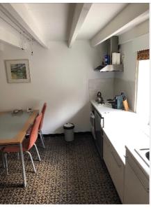 a kitchen with a table and a table and chairs at Home Brasserie in Wanlin