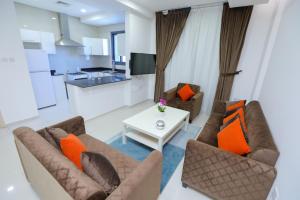 a living room with two couches and a table at ماجيك سويت بوليفارد Magic Suite Boulevard in Kuwait