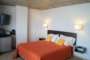 Una cama o camas en una habitación de Morada Sur Apart Hotel