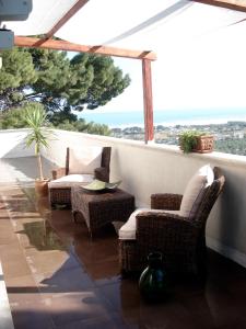 a patio with wicker chairs and a table on a balcony at Residenza Collina Dei Pini in Vieste +51 photos