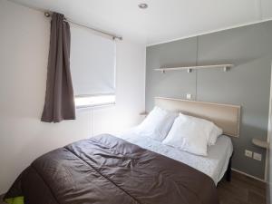 Postel nebo postele na pokoji v ubytování Camping L'Orangeraie