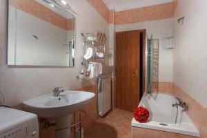 a bathroom with a sink and a bath tub at The Reef Apartment in Sorrento