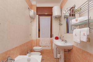 a bathroom with a sink and a toilet at The Reef Apartment in Sorrento