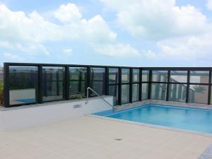 a swimming pool on top of a building at Pajucara Flat in Maceió