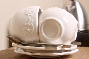 a tea set with a cup and a spoon on a table at Zoe Bush Lodge in Pretoria
