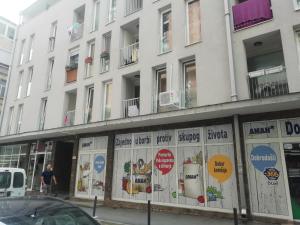 a white building with signs on the side of it at Apartman Centar 2 in Užice