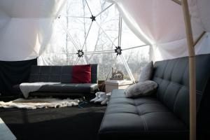 a living room with a couch and a tent at Aurora Dome in Kiruna