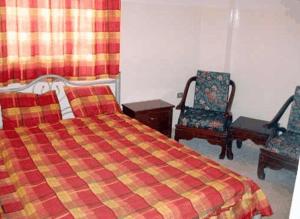 A bed or beds in a room at Farah Hotel