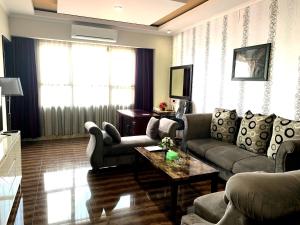 a living room with a couch and a table at Pacific Hotel Ambon in Ambon