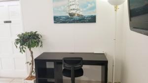 a desk with a chair and a picture of a ship at Belleview Gulf Condos in Clearwater Beach +21 photos