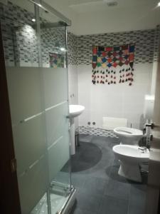 a bathroom with two toilets and a glass shower at Ila in Fiera in Rome