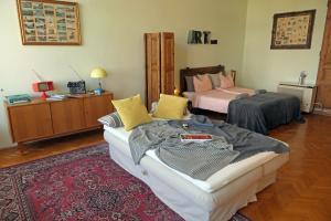 a bedroom with two beds and a red rug at ART HoMe in Szombathely