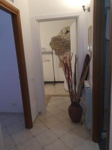 a hallway with a fireplace and a vase on a tile floor at Ila in Fiera in Rome +17 photos