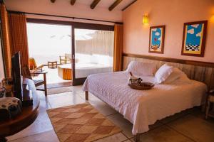 a bedroom with a bed with a cat in a bowl on it at Resort Refúgio do Estaleiro in Porto Belo