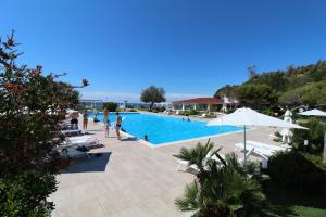 a swimming pool with people in a resort at BV Kalafiorita Resort in Zambrone