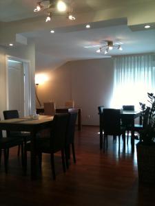 a dining room with tables and chairs and a window at Rooms Villa Aria in Sesvete