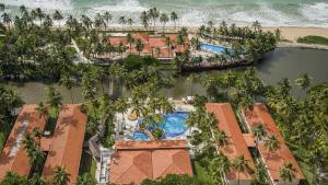an aerial view of a resort with a pool and the ocean at Jatiuca Hotel & Resort in Maceió
