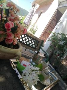 a tray with pots of flowers on a balcony at B&B Domus Deiana in Mamoiada