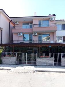 a large building with a fence in front of it at Къща за гости Ганчеви in Sozopol