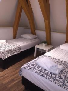 a room with two beds and a table at Central sweet BNB in Amsterdam