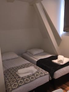 a room with two beds with towels on them at Central sweet BNB in Amsterdam