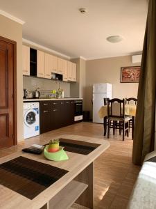 a kitchen and living room with a table with a plate on it at Jacky's Apartament - Апартамент в Свети Влас in Sveti Vlas